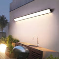 Minimalist long strip outdoor wall lamp lighting a patio