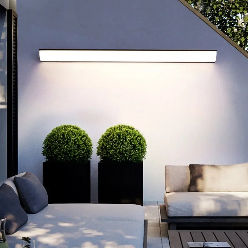Outdoor wall light illuminating a courtyard seating area